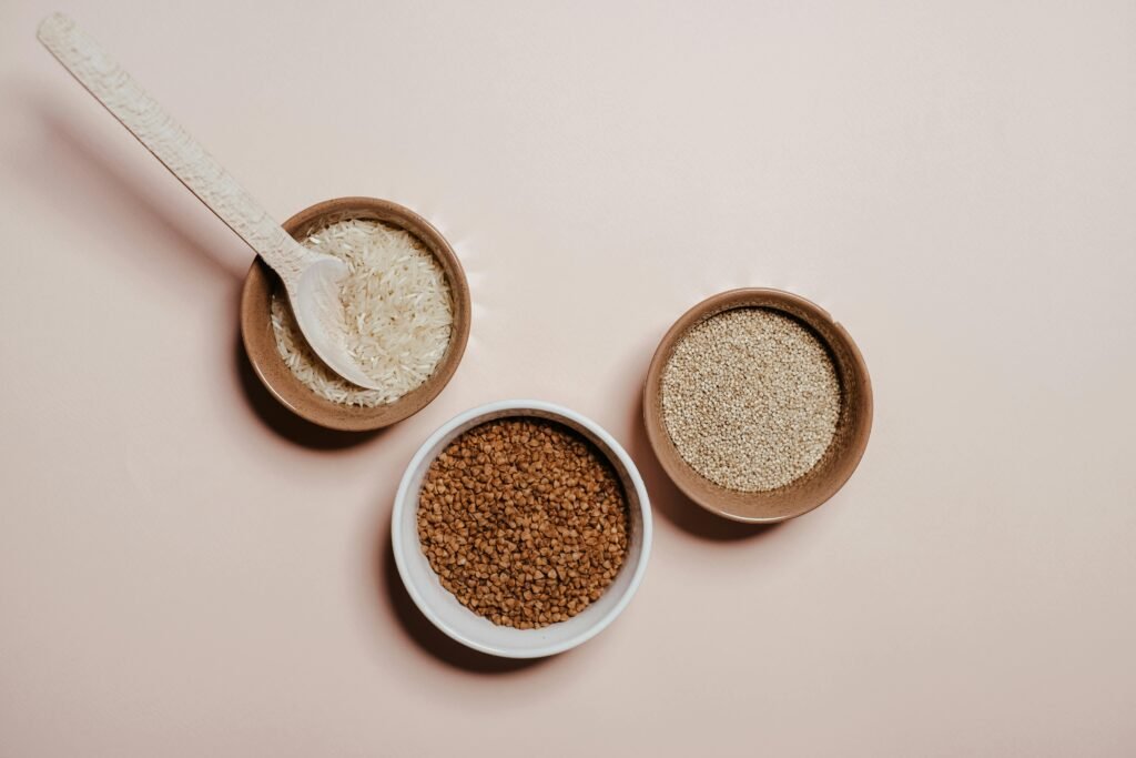 Bowls with Seeds and Spoon on White Background